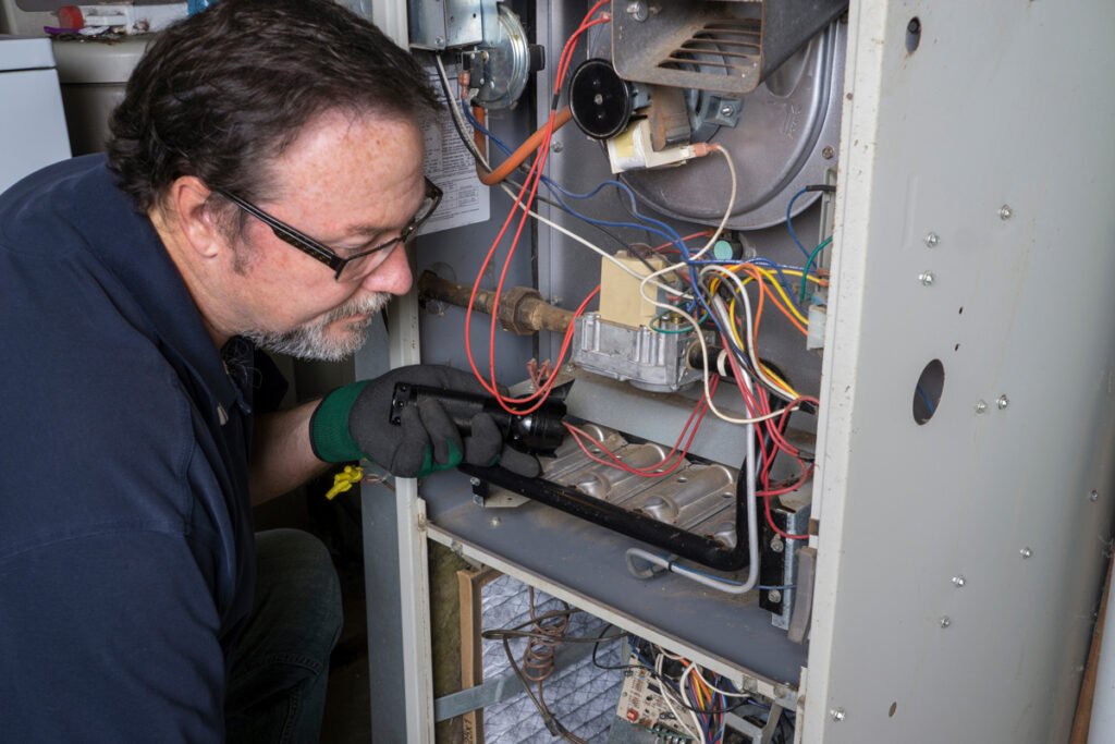 A North Fort Myers HVAC contractor installing an HVAC system.